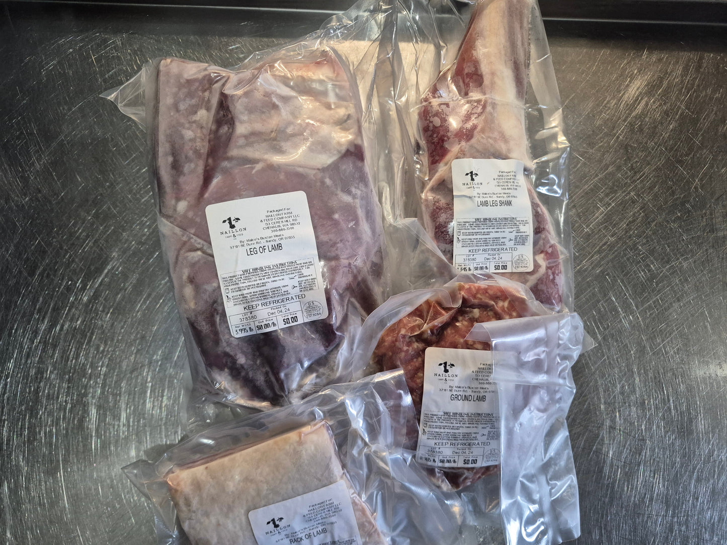 Vacuum-sealed packages of raw meat on a metallic surface